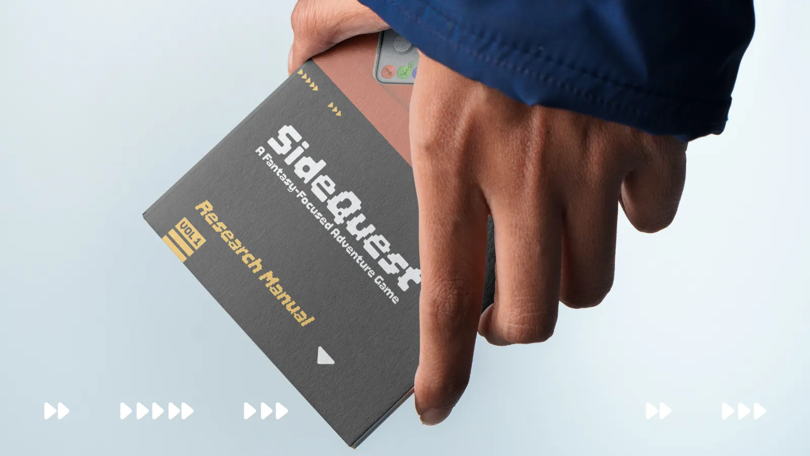 Hand holding a printed manual with SideQuest branding