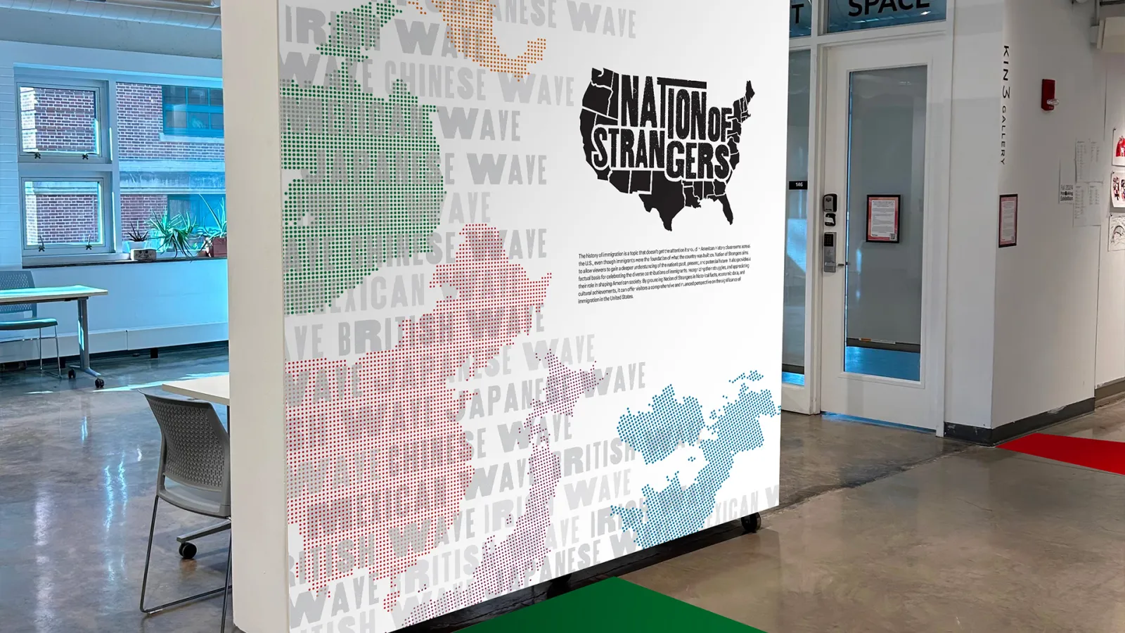 This image displays the “Nation of Strangers” exhibition introduction wall at the front entrance of Hopkins Hall.