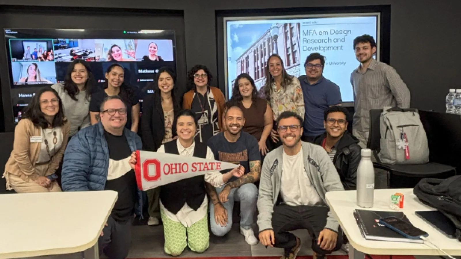  Barbara holds an Ohio State flag in front of a group of people