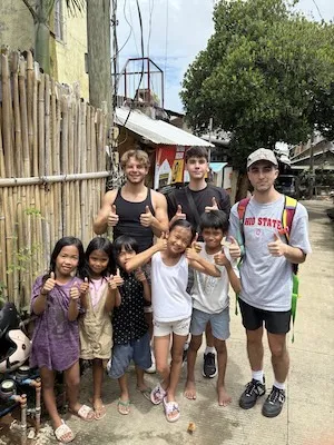 Phillip Biondo with other NUS IEP participants and local children.