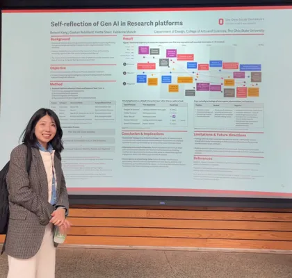 A woman stands in front of a research poster