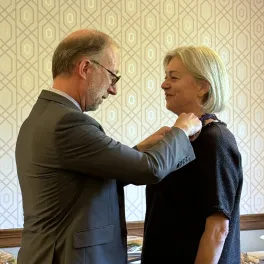 Yannick Tagand, Consul General of France, confering the Ordre des Palmes Académiques upon Dr. Munch.